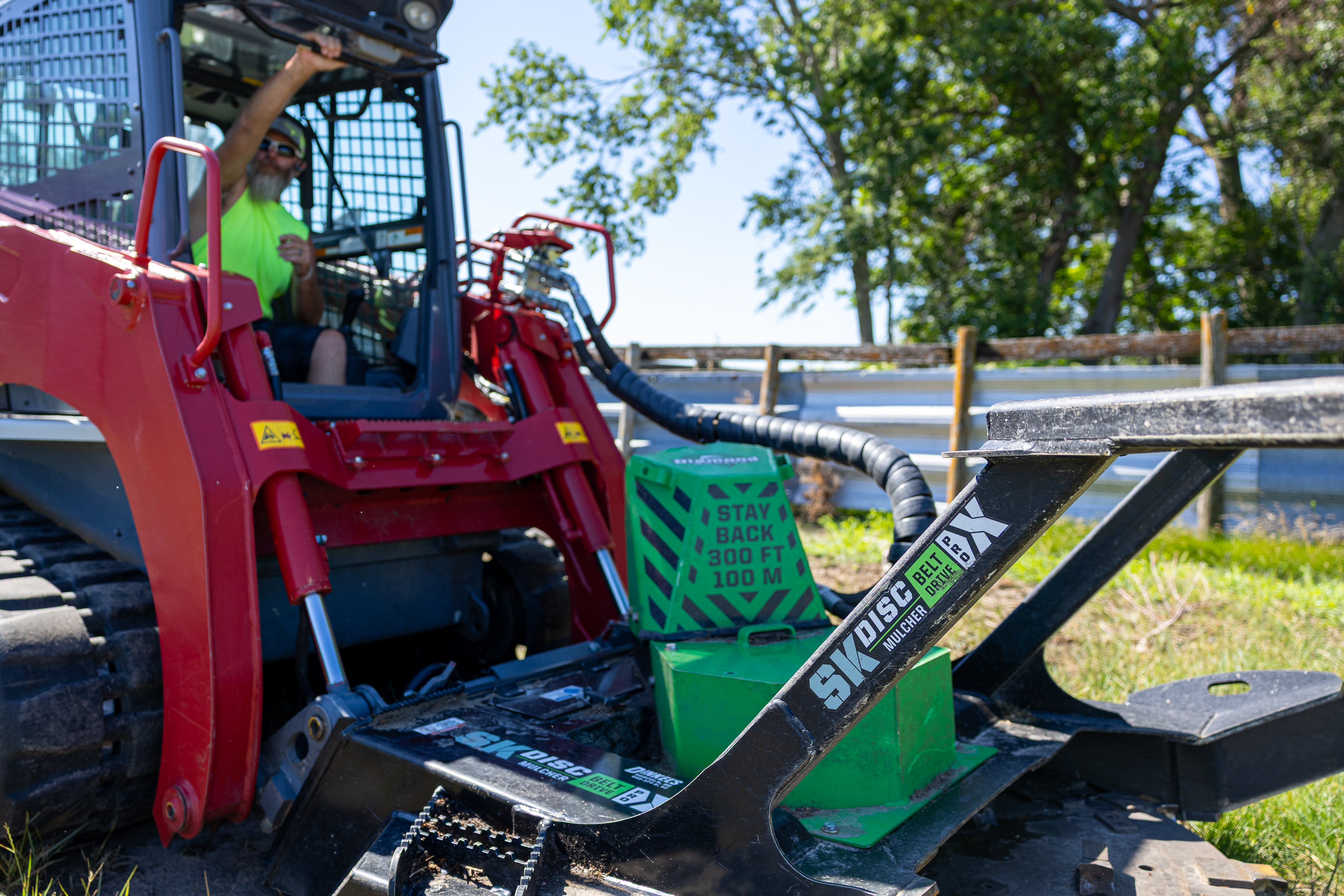person closing the skid steer door